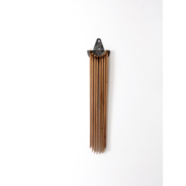 This antique wall drying rack features an expanding accordion design with warm wood slats and aged metal hardware. It...