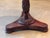 English mahogany side table with a circular dished top raised on a turned and tapering pedestal carved with foliate...