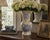 A decorative late-20th-century porcelain vase with an elegant baluster body, flared trumpet neck, and softly periwinkle-...