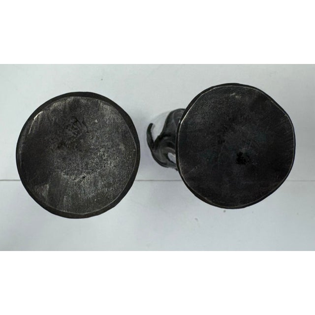 Dramatic pair of sculptural champagne flutes featuring elegant nude female figures forming the stems. Each glass combines...