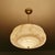 Art Deco pendant lamp from the 1930s, stepped pink mottled marble glass shade with darker streaks mounted on a bronze...