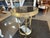 This is a vintage brass tripod table. It carries mid century modern aesthetic qualities. The two granite tops are very...