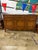 Elegant French Provincial buffet featuring three drawers, paneled cabinet doors, cabriole legs, and decorative brass...
