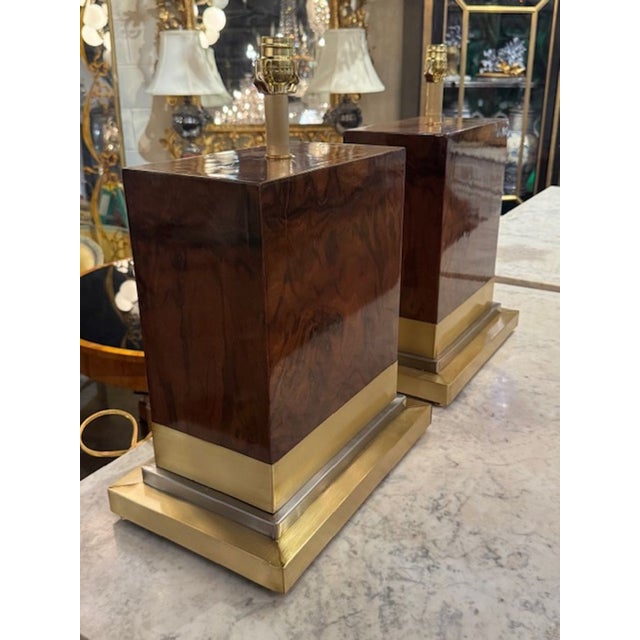 This product is a stylish pair of modern burlwood and brass lamps that add a touch of sophistication to any room. The...