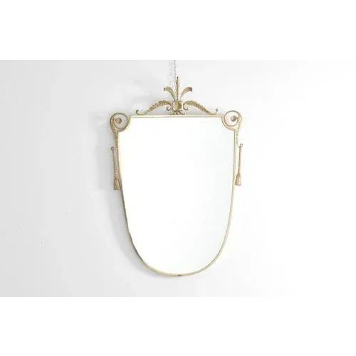 Valuable classic style wall mirror with frame and elegant decorative elements in golden brass. Captivating Italian...