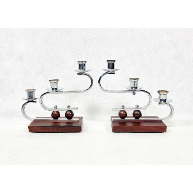 A pair of candlesticks comes from Germany from the 1930s. Candlesticks made of brass (wooden base), chrome plated, in very...