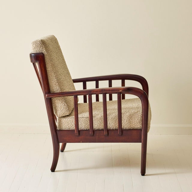 Armchair attributed to Vittorio Valabrega, dating to the 1940s. The design features a sculptural solid wood frame with...