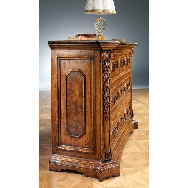 Handcrafted in Italy from solid walnut, this three-drawer chest features a clean rectangular form enriched with carved...