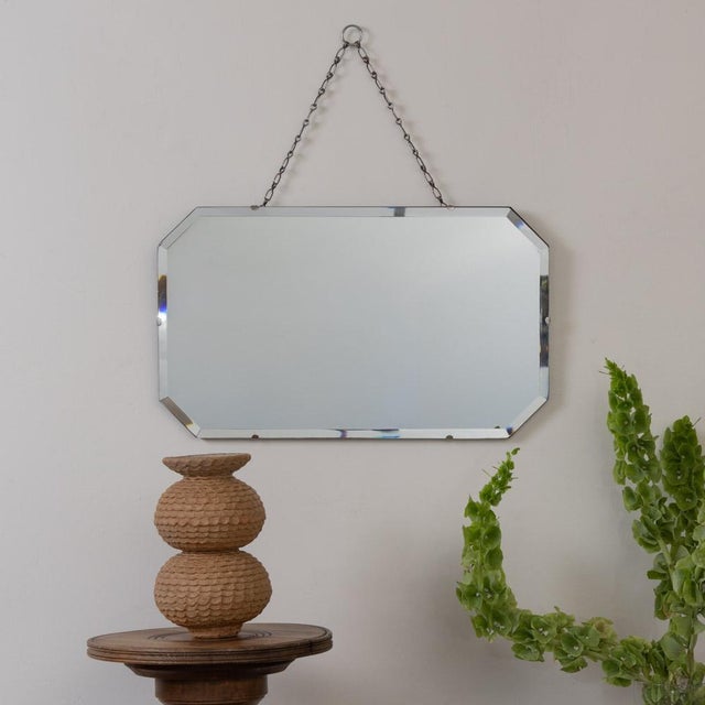 Beautiful Art Deco mirror from France, 1930s. Rectangular mirror with beveled octagonal edge secured to a wooden back....