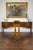 An English oak hall chair from the mid-19th century, with pierced back, carved letters and wooden seat. Created in England...