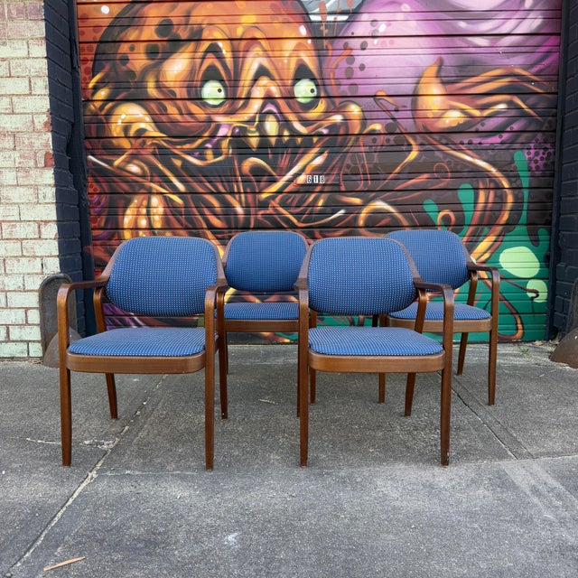This is a set of 4 Don Pettit for Knoll Model 1105 armchairs. They feature a dark stained bentwood frame and blue and tan...