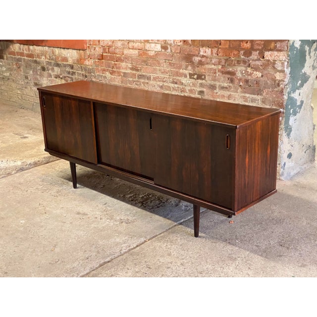 Stylish Danish Modern Dyrlund triple sliding door sideboard. Signed on the inside of top drawer with a paper label, DB...