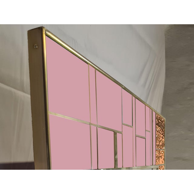 This refined wall mirror, crafted from punched brass and pink Murano glass, embodies the elegance of Italian design. The...