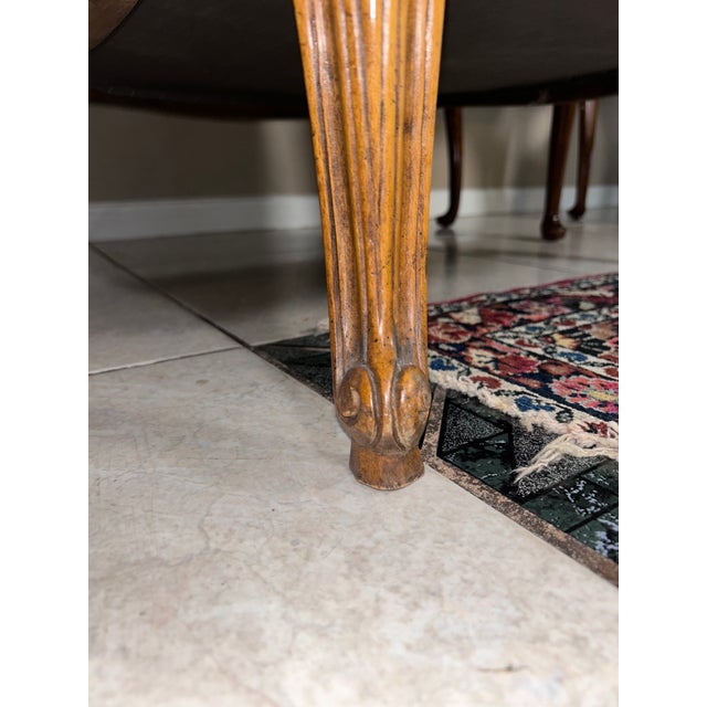 Elegant pair of French Provincial lounge chairs featuring carved wood frames with graceful cabriole legs, scrolled arms,...