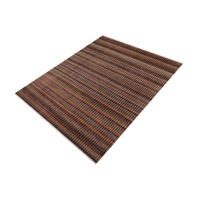 Elevate your interior with this hand-knotted high-low wool area rug, designed to bring depth and dimension to any room....