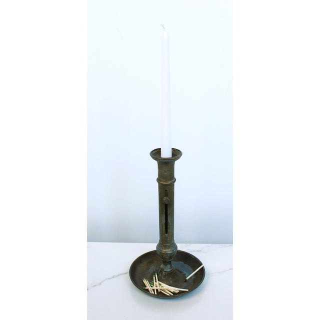 A authentic French 19th Century brass chamberstick with heavy tarnish. These candle holders often had functioning candle...