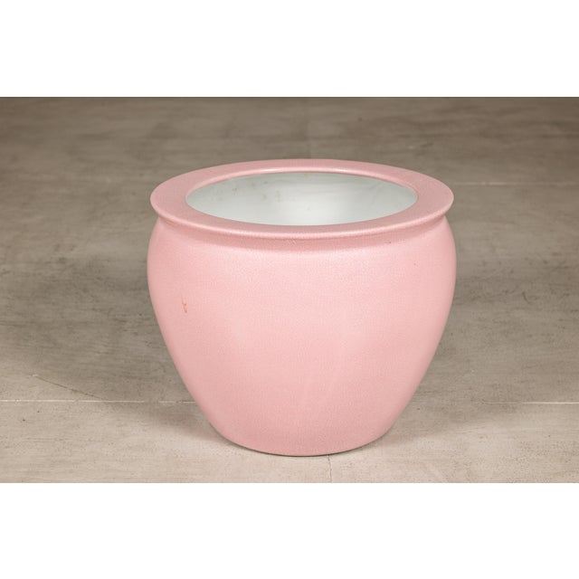 This vintage Chinese ceramic planter features a softly rounded form finished in a delicate blush pink glaze with an...