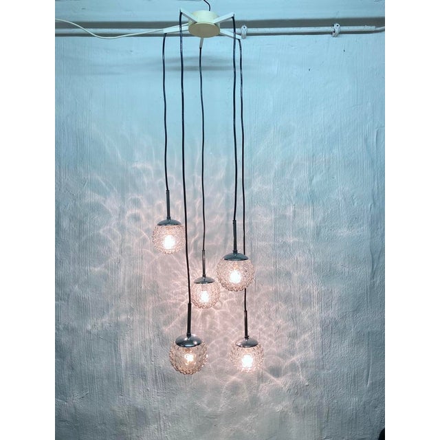 One pendant lamp from the 1970s, five-light, E14 sockets, designed by Rolf Krüger for Staff. Glass, chrome-plated metal....