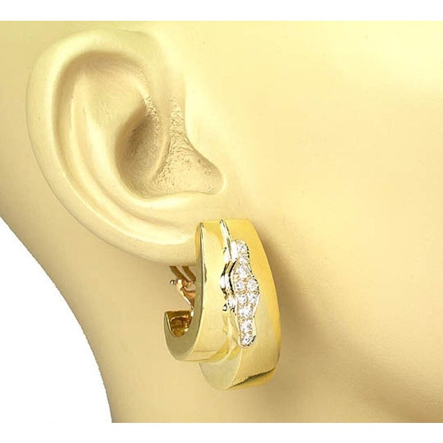 The Boris Lebeau Retro Diamond 18k Yellow Gold Double Oval Hoop Earrings are a luxurious and elegant pair of accessories....