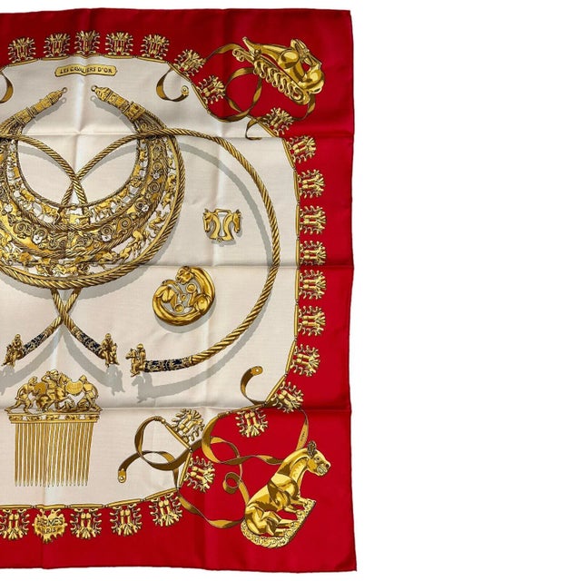 About This Piece: The Hermes "Les Cavaliers D'Or" scarf, meticulously crafted from sumptuous 90cm red silk, showcases...