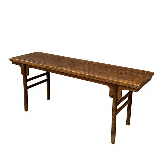 Constructed from solid elm, this classic recessed-leg table (pingtou'an) features a flush-sided rectangular top with a...