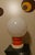 1970s table lamp featuring a large, spherical opal diffuser. The design recalls mid-century Pop Art. It features an orange...