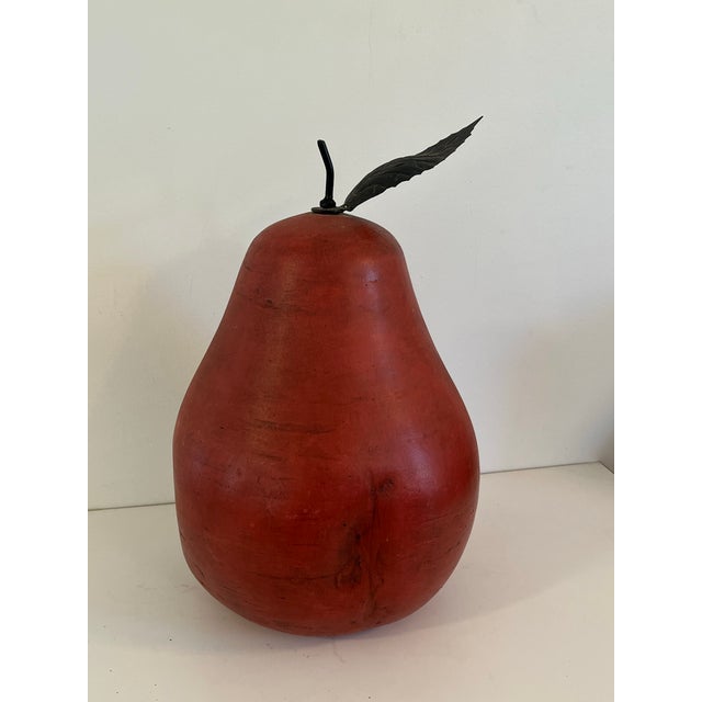 Realistic extra large, red porcelain dimpled pear with metal stem and leaves Black felt round piece covers the bottom....