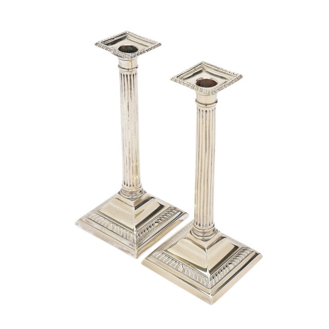 Pair of English cast Paktong columnar candlesticks with a gadroon edged square bobesh. The fluted columnar shaft rests on...