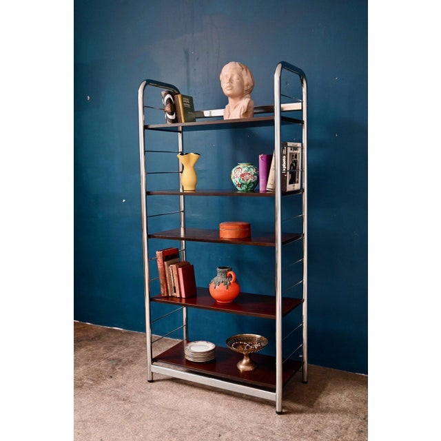 This freestanding bookcase from the 1970s-80s is appealing thanks to the warm combination of its chrome-plated steel and...