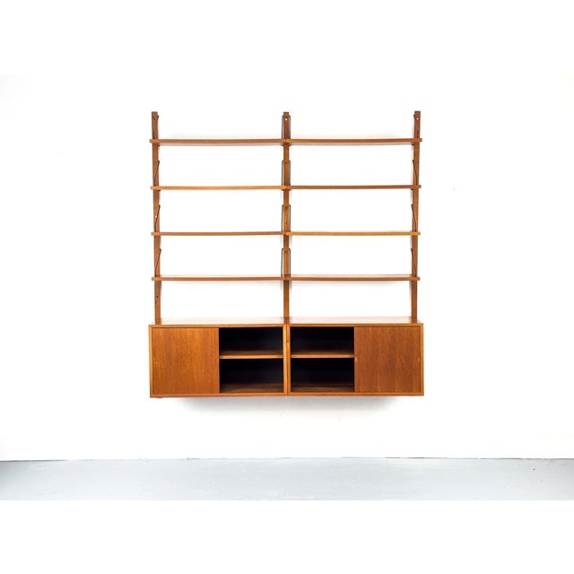 Modular "Cado Royal" shelving system in exquisite teak – a true Danish Modern design classic by Poul Cadovius. The set...