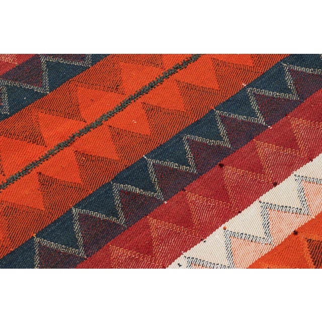 This vintage 5x8 Persian kilim is a mid-century Qashqai tribal rug, handwoven in wool circa 1950-1960. On the Design: This...