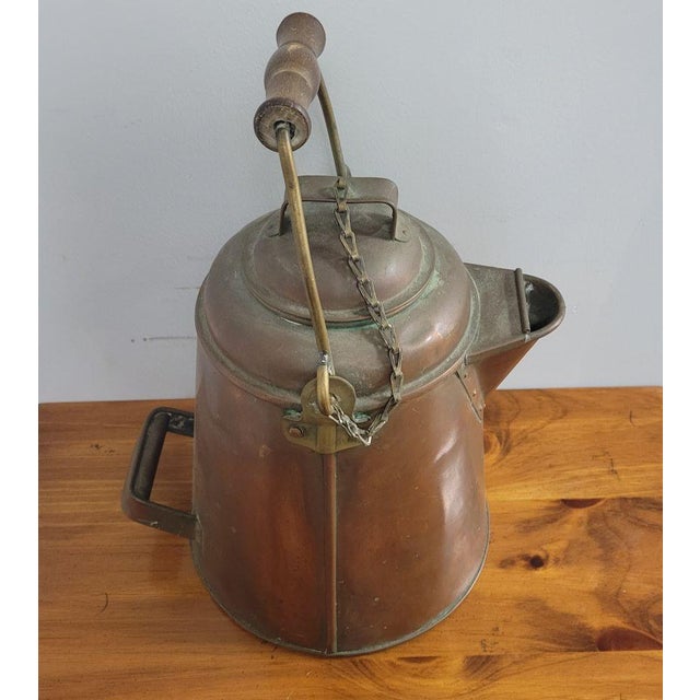 Large copper coffee pot or kettle made of copper over tin with a wood handle and brass bale and attaching brass hardware....