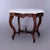 An antique Rococo turtle top parlor table offers beveled and shaped marble top over walnut base raised on cabriole legs...