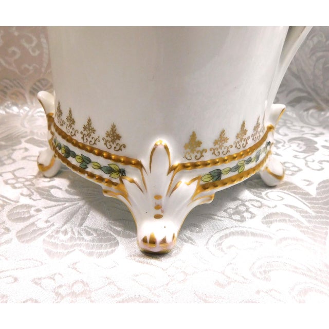 This is a white Reinhold Schlegelmilch RS Prussia chocolate pot with green and gold trim. The main portion of the pot is...