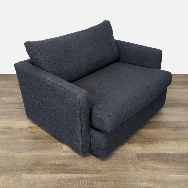 Features deep low seat with slim track arms. Brand: Crate & Barrel. Original Price: $1279. Dimensions (in): 49W x 40D x 35H.
