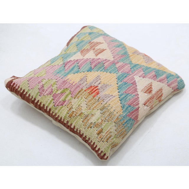 A one-of-a-kind handwoven Afghan wool kilim accent pillow featuring pastel triangle lattice. Cut and sewn by hand from a...