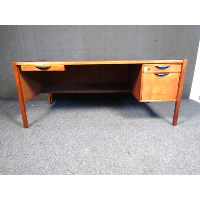 Mid-century modern writing desk Attributed Harvey Probber. This desk features walnut construction, ample leg room, and...
