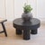 The table is a newly produced piece of furniture with a round top and three cylindrical legs made of wood treated entirely...