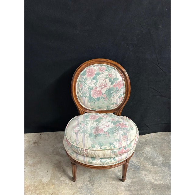 Charming vintage Louis XVI style slipper or chauffeuse chair with an oval medallion back, fluted tapered legs, carved...