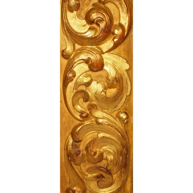 An 18th century gold gilt wood panel. Panel is heavy solid wood with three carved swirl patterns in line. Measures 41 ½” x...