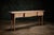 This is a contemporary European studio-made oak console table offering a sturdy and elegant surface for display or...