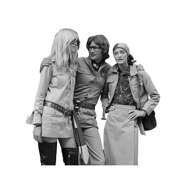 By photographer John Minihan, Yves Saint Laurent, French designer with two fashion models, Betty Catroux (left) and Loulou...