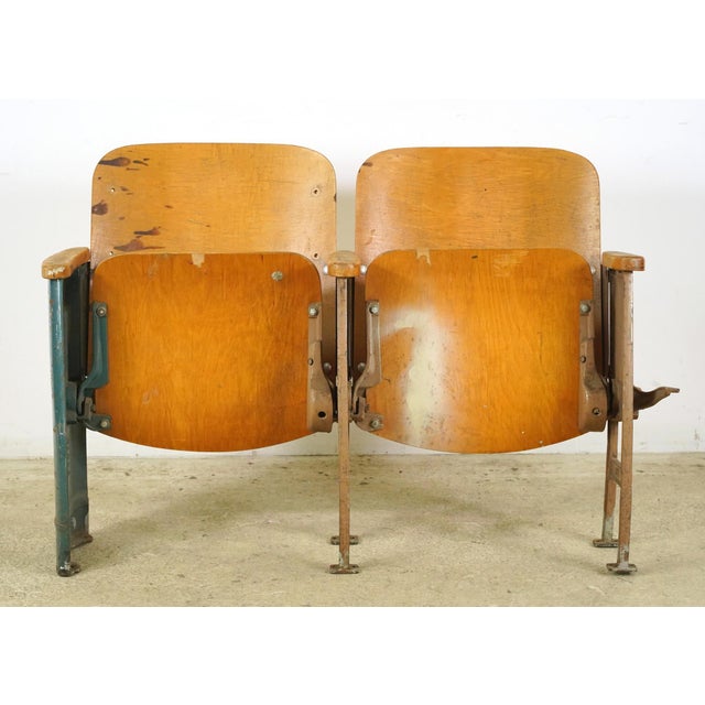 Art Deco style theater seats made of molded plywood backrests and flip-up seats, solid wood armrests, and heavy cast iron...