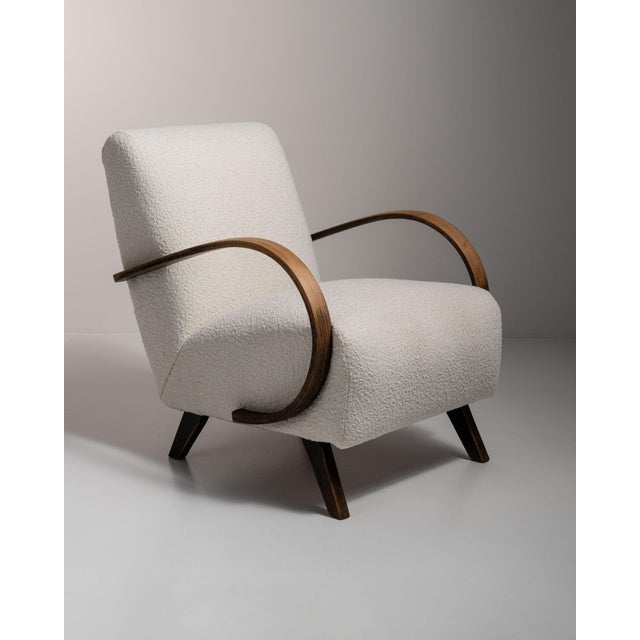 Curved-arm lounge chair in Warm Ivory Boucle. Its warm ivory boucle finish sets off sculptural bentwood arms, ivory boucle...