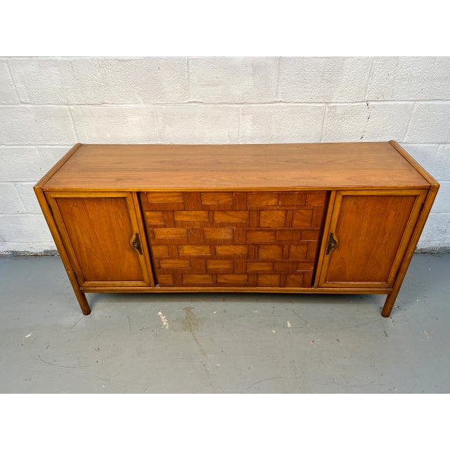 Handsome mid-century modern walnut server featuring finely crafted dovetail drawers and distinctive sculptural pulls. A...