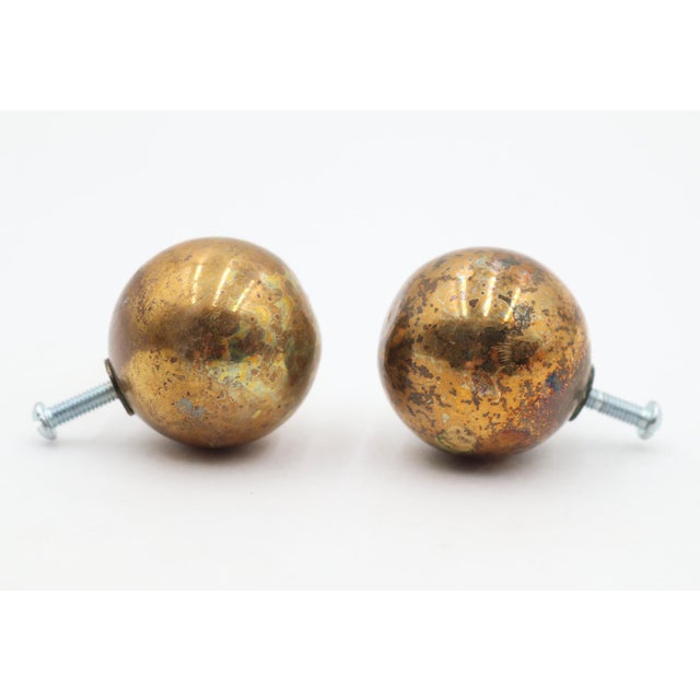 Reclaimed ball shaped cabinet or drawer knobs made of polished brass. Mounting screws are included. Good condition with...