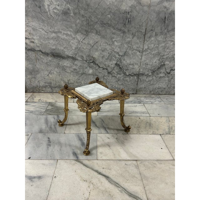 A striking Victorian plant stand with a marble removable top and heavy brass sculptural brass base.
