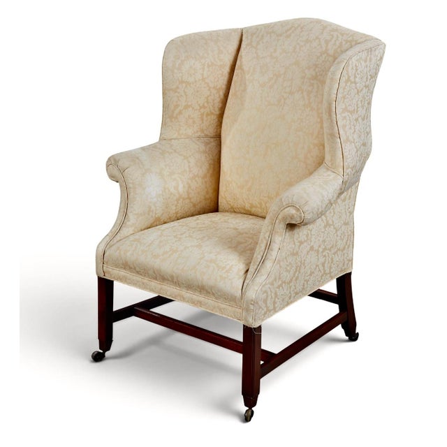 The is a wonderful example of a late George III Wing Back Chair with neoclassical legs terminating in casters and...