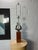 A sophisticated Mid-Century Modern table lamp featuring a highly polished chrome sculptural form rising from a solid...