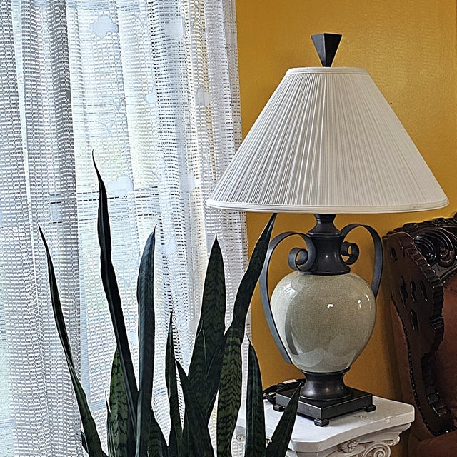 Sculptural traditional table lamp styled after Ashley Gavivi, centered by an off-white ceramic urn with finely textured...